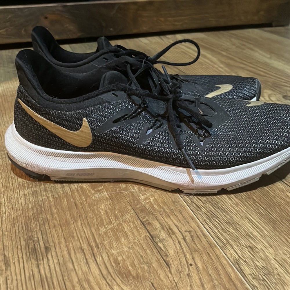 Black and gold Nike running sneakers
